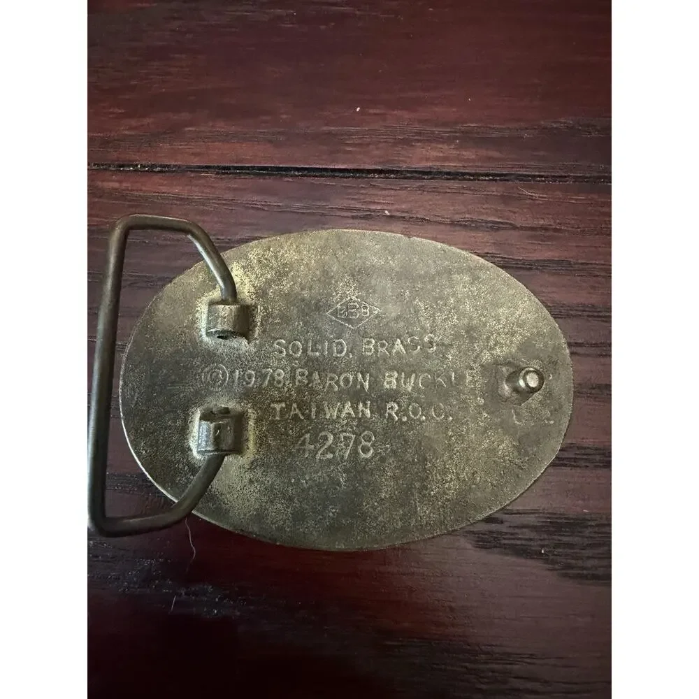 This is a vintage brass Masonic belt buckle.